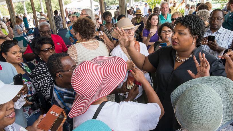 Georgia Gubernatorial candidate Stacey Abrams tries to organize a group of supporters who want to take a photo with her following a campaign stop in Brunswick, Georgia, September 23, 2018. .