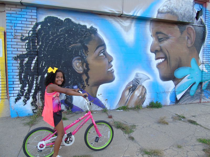 Mari Copeny in front of her mural with President Obama in Flint, Mich. The mural was torn down in August, despite the family's efforts to save it.