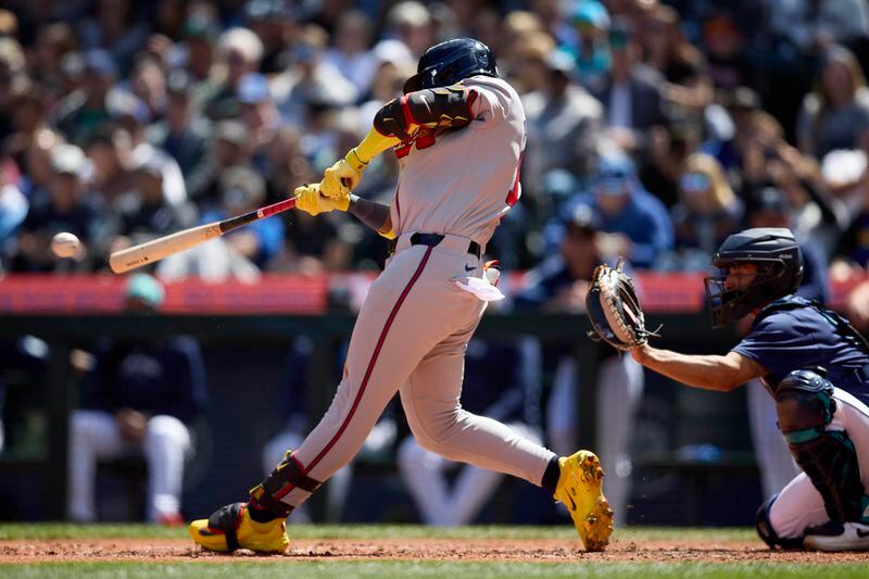 Atlanta Braves' Ronald Acuña Jr. hits a single scoring a run against the Seattle Mariners during the fourth inning of a baseball game, Wednesday, May 1, 2024, in Seattle. (AP Photo/John Froschauer)
