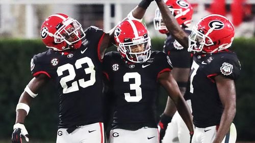 Georgia defensive backs Mark Webb (from left), Tyson Campbell, and Tyrique Stevenson celebrate stopping Mississippi State during the second half Saturday, Nov. 21, 2020, in Athens. (Curtis Compton / Curtis.Compton@ajc.com)
