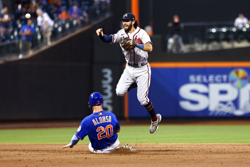 Atlanta Braves shortstop Dansby Swanson makes an error throwing to first base as New York Mets' Pete Alonso (20) is out at second base during the third inning of the second game of a baseball doubleheader Saturday, Aug. 6, 2022, in New York. (AP Photo/Jessie Alcheh)