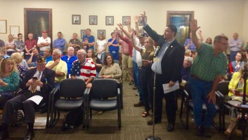A crowd of unhappy Peachtree City residents raise their hands to tell the City Council they want to speak at a meeting on Thursday, April 18, 2019. The topic? An effort by Peachtree City council members to pass an ordinance that would allow city officials to use city funds to pay for lawsuits against locals who criticize them.