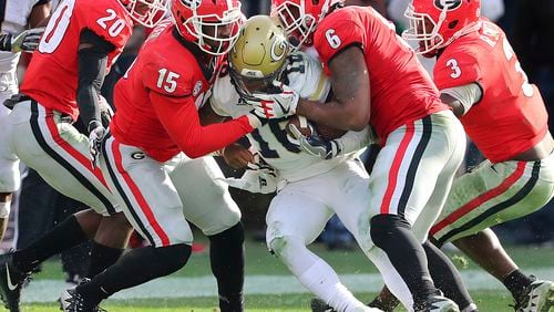 Georgia defenders J.R. Reed, from left, D'Andre Walker, Natrez Patrick and Roquan Smith swarm Georgia Tech quarterback TaQuon Marshall in the second half of an NCAA college football game Saturday, Nov. 25, 2017, in Atlanta. Georgia won, 38-7. (Curtis Compton/Atlanta Journal-Constitution via AP)