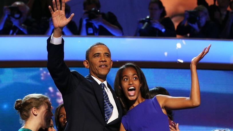 CHARLOTTE, NC - SEPTEMBER 06: Democratic presidential candidate, U.S. President Barack Obama waves on stage with Malia Obama after accepting the nomination during the final day of the Democratic National Convention at Time Warner Cable Arena on September 6, 2012 in Charlotte, North Carolina. The DNC, which concludes today, nominated U.S. President Barack Obama as the Democratic presidential candidate. (Photo by Chip Somodevilla/Getty Images)