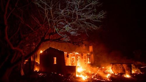 Flames consume a home on N. Fairview Ave. as the Holiday fire burns in Goleta, Calif., on Saturday, July 7, 2018. The blaze has destroyed multiple homes. (AP Photo/Noah Berger)
