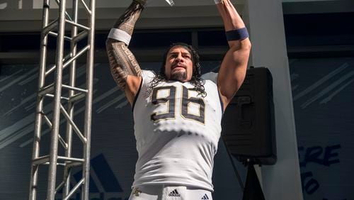 Professional wrestler and former Georgia Tech football player Roman Reigns models the new football uniforms during a reveal party in Atlanta, Friday, August 3, 2018.  (ALYSSA POINTER/ALYSSA.POINTER@AJC.COM)