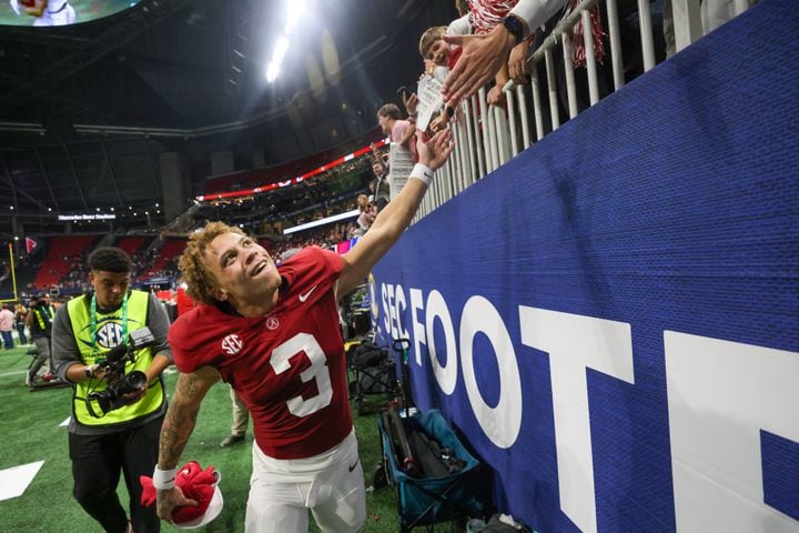 Alabama Crimson Tide wide receiver Jermaine Burton (3) celebrates with fans after defeating the Georgia Bulldogs 27-24 in the SEC Championship football game at the Mercedes-Benz Stadium in Atlanta, on Saturday, December 2, 2023. (Jason Getz / Jason.Getz@ajc.com)