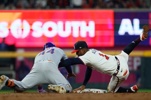 Atlanta Braves second base Ozzie Albies (1) tags out New York Mets outfielder Harrison Bader (44) during the second inning against the New York Mets at Truist Park on Tuesday, April 9, 2024.  Miguel Martinez / miguel.martinezjimenez@ajc.com