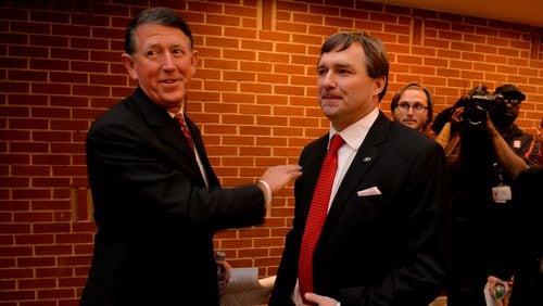 December 7, 2015 Athens, GA: Kirby Smart, right, was given a "Go get em" and a pat on the back by UGA Director of Athletics Greg McGarity before Smart was introduced as the new coach of the University of Georgia during a press conference Monday December 7, 2015. Smart was a former UGA player and coach. Smart replaced Mark Richt after 15 seasons at the helm of the Bulldogs. BRANT SANDERLIN/BSANDERLIN@AJC.COM