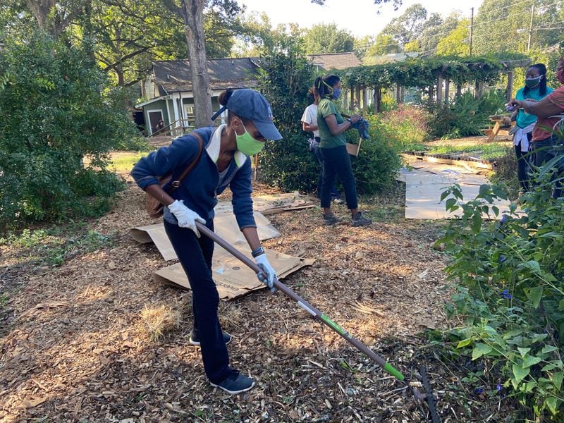 Edgewood resident Melika Heinrich works  in the community garden down the street from where Benjamin was killed. The mother of two said she loves the neighborhood, but has concerns about letting her young daughters play in the garden.