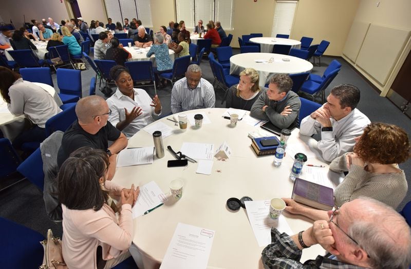 Clockwise from left, Mary Louise and Stephen Gilkenson, Corliss and Melvin Kinard, Denise and Mike Moss, Eric and Becca Anderson, and Myles Lorenzen discuss during a "Grace and Race" seminar at Eagles Nest Church in Roswell on Saturday, May 6, 2017.  HYOSUB SHIN / HSHIN@AJC.COM