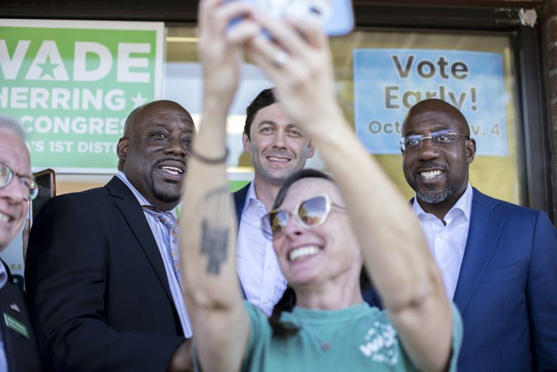 Jessica Leigh Lebos, bottom center, take a selfie with U.S. Sen.s Raphael Warnock and Jon Ossoff, along with Savannah Mayor Van Johnson, who is on the left. (AJC Photo/Stephen B. Morton)