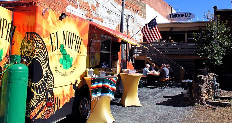 Truck & Tap is tucked in between two shops on Main Street in downtown Woodstock Patrons can enjoy a meal from a rotation of food trucks and sip on craft beer. Photo by Jennifer Carter.