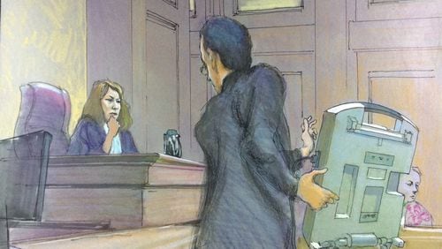 U.S. District Judge Amy Totenberg listened in a federal court hearing in September 2018 as Alex Halderman, a University of Michigan computer science professor, demonstrates how an electronic voting machine like those used in Georgia could be hacked. Totenberg is overseeing a lawsuit that asked her to invalidate Georgia’s 27,000 touchscreen voting machines and replace them with paper ballots. RICHARD MILLER / CONTRIBUTED