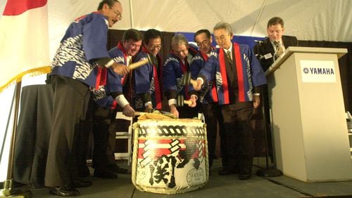 In this AJC file photo from 2000, Japanese executives and their American counterparts busted a keg of saki at groundbreaking ceremonies for the plant expansion at Yamaha Motor Manufacturing in Newnan. STAFF PHOTO BY W.A. BRIDGES JR.