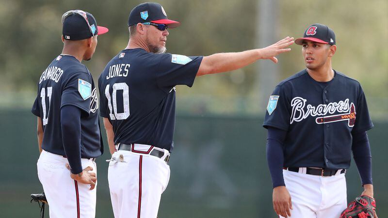 Feb 19, 2018 Lake Buena Vista: Braves recently elected Hall of Fame third baseman Chipper Jones works at third base with Johan Camargo (left) and Rio Ruiz at spring training during the first full squad workout on Monday, Feb 19, 2018, at the ESPN Wide World of Sports Complex in Lake Buena Vista. Jones was helping coach the team for the day.     Curtis Compton/ccompton@ajc.com