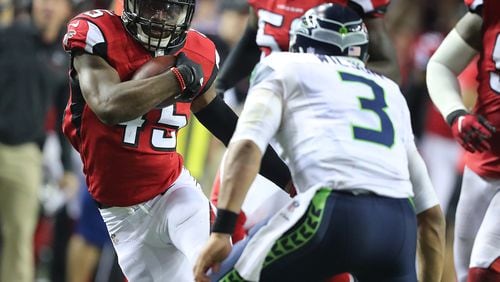 January 14, 2017, Atlanta: Falcons linebacker Deion Jones intercepts Seahawks quarterback Russell Wilson, who trys to make the tackle, in the final minutes of the fourth quarter to seal a 36-20 victory in a NFL football NFC divisional playoff game on Saturday, Jan. 14, 2017, in Atlanta.     Curtis Compton/ccompton@ajc.com