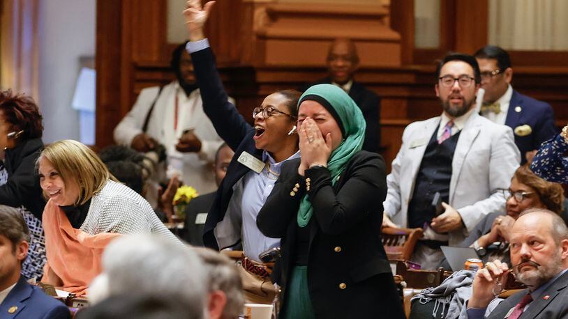 Rep. Imani Barnes (D-Tucker) and Rep. Ruwa Romman (D-Duluth) cheer after HB 233 fails to pass on Wednesday, March 29, 2023. The bill would send $6,500 a year to parents to help cover education-related costs, including private school tuition. (Natrice Miller/ natrice.miller@ajc.com)