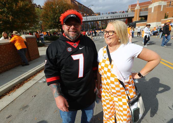 Georgia fan Stacy Teeters, Chickamauga, says his wife Jessica, a Tennessee fan, will be sleeping on the sofa tonight if Tennessee happens to beat Georgia in their NCAA college football game on Saturday, Nov. 18, 2023, in Knoxville.  Curtis Compton for the Atlanta Journal Constitution