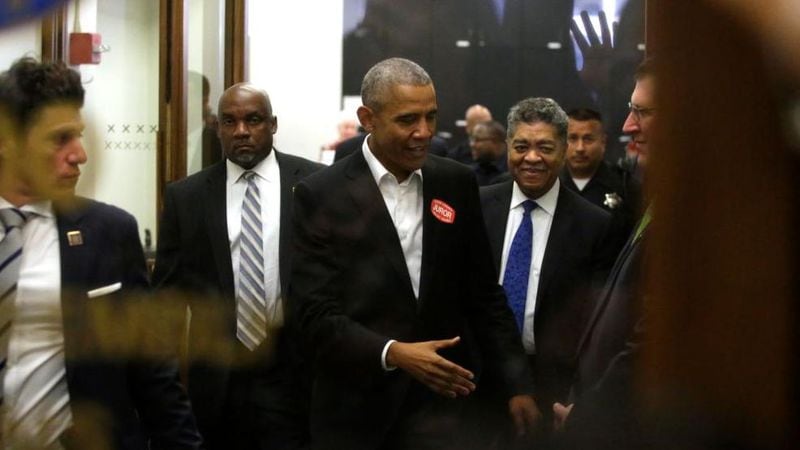 Former President Barack Obama extends his hand as he attends Cook County jury duty at the Daley Center on November 8, 2017 in Chicago, Illinois. Jurors receive $17.20 for each day of jury service.