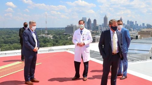 Gov. Brian Kemp and Piedmont Healthcare staffers atop the new Marcus Tower.