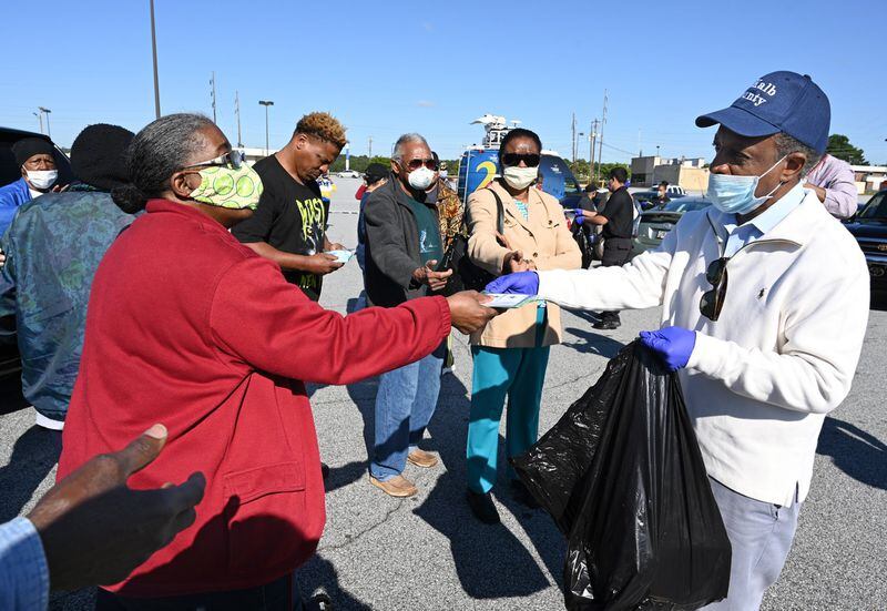DeKalb County CEO Michael Thurmond hands COVID-19 care kits out to residents at Big Lots parking lot on Candler Road in Decatur on Saturday, May 9, 2020. DeKalb County is passing out thousands of the kits, which have masks and sanitizer, to residents to mitigate the spread of COVID-19. DeKalb County Board of Health is supporting the initiative. (Photo: Hyosub Shin / Hyosub.Shin@ajc.com)