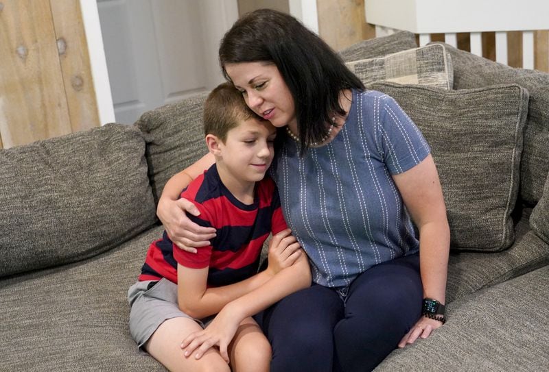 Misti Allison sits with her son, Blake, 8, at her home, Saturday, July 15, 2023, in East Palestine. Allison testified before a Senate committee in March concerning the Feb. 3 Norfolk Southern freight train derailment. (Matt Freed for the Atlanta Journal Constitution)