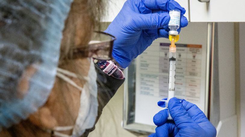Elizabeth Vogel MN MPH fills syringes with the Monkeypox vaccination, Aug. 5, 2022. Steve Schaefer / steve.schaefer@ajc.com)