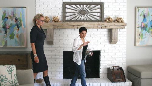 Real estate agent Collette McDonald (left) accompanies Reiki master and medium Darshana Patel through a house cleansing ritual. CREDIT: Stephanie Miller.