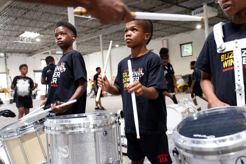 Evan Wright, 11, left, and Chioma Narcisse-WIlliams, 9, listen to instructions while practicing for their next televised competition. (Ben Gray / Ben@BenGray.com)