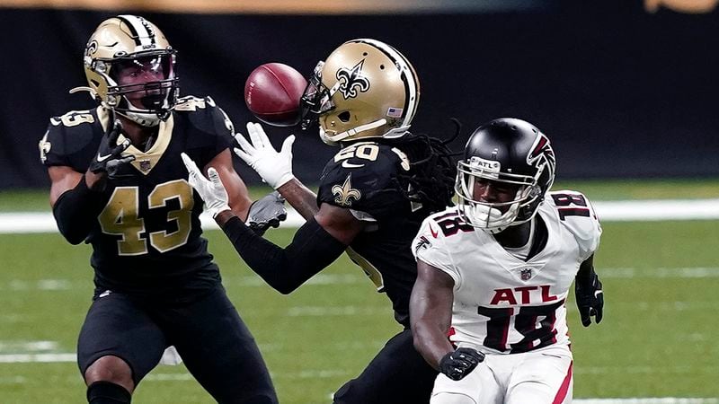 Saints cornerback Janoris Jenkins (20) intercepts a pass that was intended for Falcons wide receiver Calvin Ridley (18), next to free safety Marcus Williams (43) in the second half Sunday, Nov. 22, 2020, in New Orleans. (AP Photo/Butch Dill)