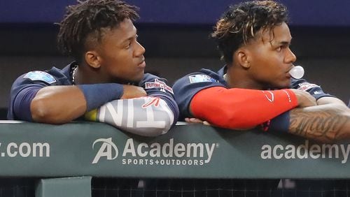 Braves outfield prospects Ronald Acuna Jr. (left)  and Cristian Pache watch the late innings of the March 27 Braves vs. Future Stars game at SunTrust Park. (Curtis Compton/ccompton@ajc.com)