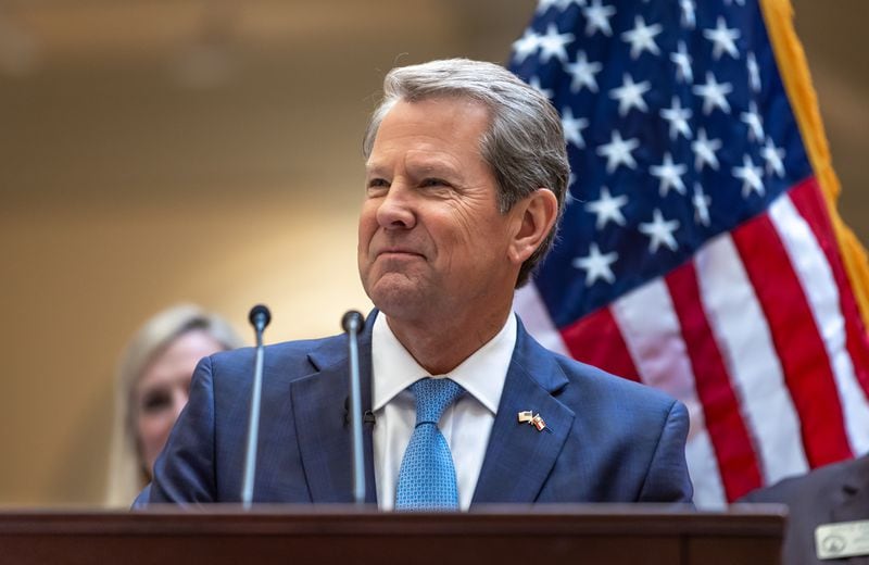 Gov. Brian Kemp received guarded praise at the state GOP convention, which he did not attend. 