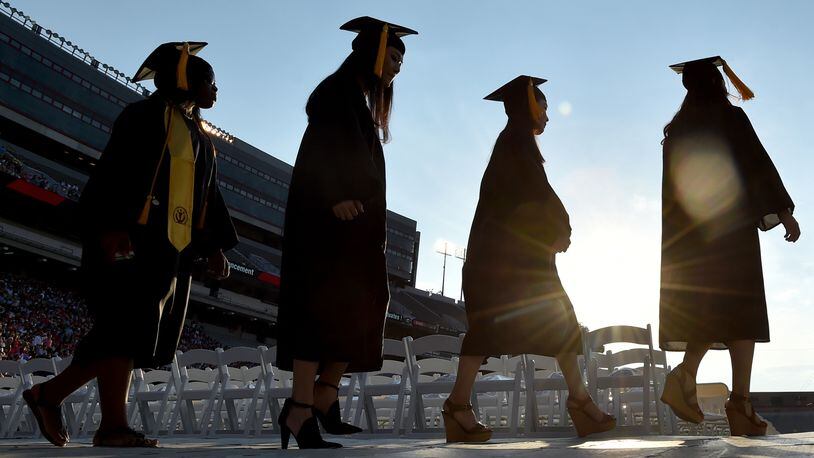 SUNSET ON THEIR COLLEGE CAREERS--May 8, 2015 Athens, GA: University of Georgia graduates file into Sanford Stadium for the undergraduate commencement Friday May 8, 2015. Almost 4500 undergraduates had their degrees conferred during the ceremony. BRANT SANDERLIN/BSANDERLIN@AJC.COM