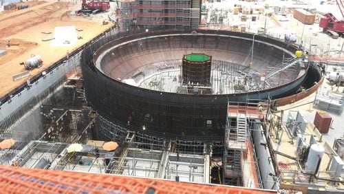 A nuclear “island” being built in 2014 during work on the Plant Vogtle expansion. The circular metal bowl of the island is placed underground, to be sheathed in rebar and concrete. At the center of the island shown is a metal structure that will hold the reactor vessel, the heart of the plant. MATT KEMPNER / MKEMPNER@AJC.COM 6/17/2014