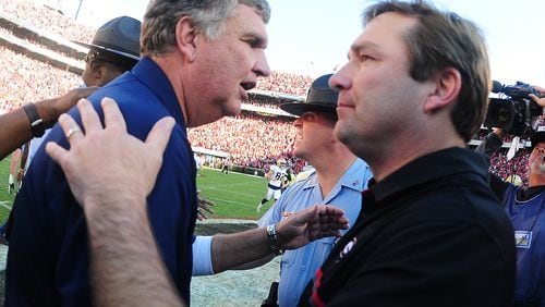 ATHENS, GA - NOVEMBER 26: Head Coach Paul Johnson (L) of the Georgia Tech Yellow Jackets is congratulated after the game by Head Coach Kirby Smart of the Georgia Bulldogs at Sanford Stadium on November 26, 2016 in Athens, Georgia. (Photo by Scott Cunningham/Getty Images)