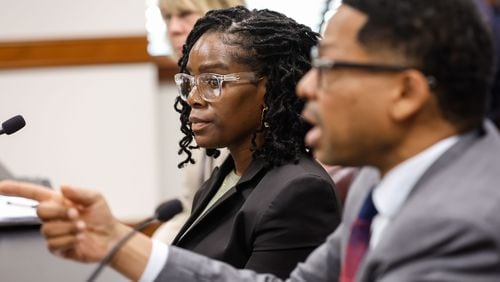 Whistleblower Amanda Timpson listens as her attorney Mario Williams speaks during a hearing about District Attorney Fani Willis at the Georgia State Capitol on Thursday, May 23, 2024. Timpson worked in the DA’s office as director of gang prevention and intervention from December 2018 to January 2022. (Natrice Miller/ AJC)