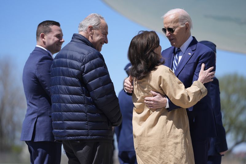President Joe Biden, from right, is greeted by New York Gov. Kathy Hochul, Senate Majority Leader Chuck Schumer, D-N.Y., and Syracuse Mayor Ben Walsh, as he arrives at Hancock Field Air National Guard Base, Thursday, April 25, 2024, in Syracuse, N.Y. (AP Photo/Evan Vucci)
