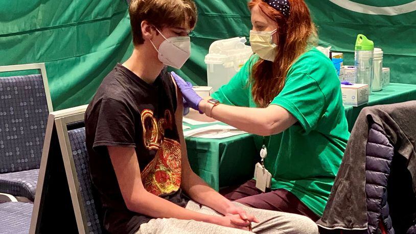 A 17-year-old  receives his Pfizer vaccine from a Children’s Healthcare of Atlanta nurse at the mass vaccination clinic at the Georgia International Convention Center. 
CONTRIBUTED