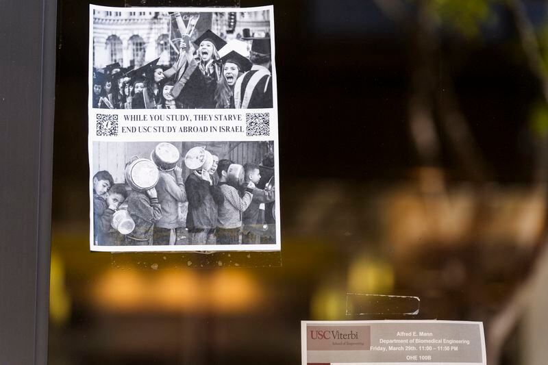 A poster hangs at the University of Southern California Viterbi School of Engineering reading "While you study They starve End USC study aboard in Israel" at the USC campus in Los Angeles, Tuesday, April 16, 2024. University of Southern California officials have canceled a commencement speech by its 2024 valedictorian, a pro-Palestinian Muslim, citing "substantial risks relating to security and disruption" of the event that draws 65,000 people to campus. (AP Photo/Damian Dovarganes)