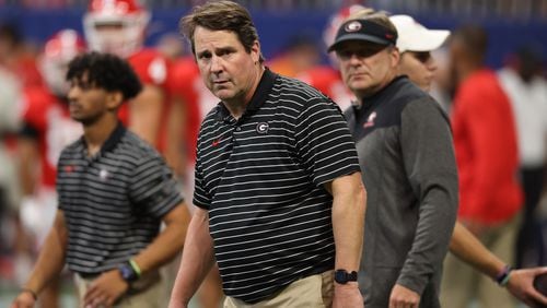 Bulldogs co-defensive coordinator Will Muschamp and coach Kirby Smart watch warmups before the Chick-fil-A Kickoff game against the Ducks. Two years after Muschamp “came home” to UGA, the reacquaintance of alumnus and alma mater appears to be going well. (Jason Getz / Jason.Getz@ajc.com)