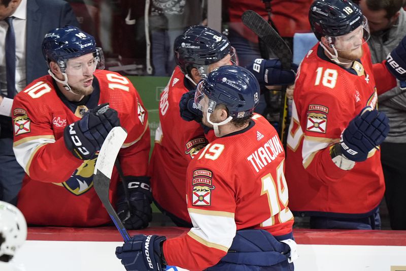 Florida Panthers center Evan Rodrigues (17) is congratulated by teammates after he scored a goal during the second period of Game 1 of the second-round series of the Stanley Cup Playoffs against the Boston Bruins, Monday, May 6, 2024, in Sunrise, Fla. (AP Photo/Wilfredo Lee)