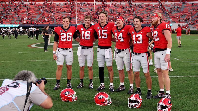 Georgia quarterbacks (from left) Collin Drake, Jackson Muschamp, Carson Beck, Gunner Stockton, Stetson Bennett and Brock Vandagriff pose for a photograph after their 55-0 win against Vanderbilt last season. The Bulldogs are searching for their next quarterback, and the competition is underway. (Jason Getz file photo / Jason.Getz@ajc.com)