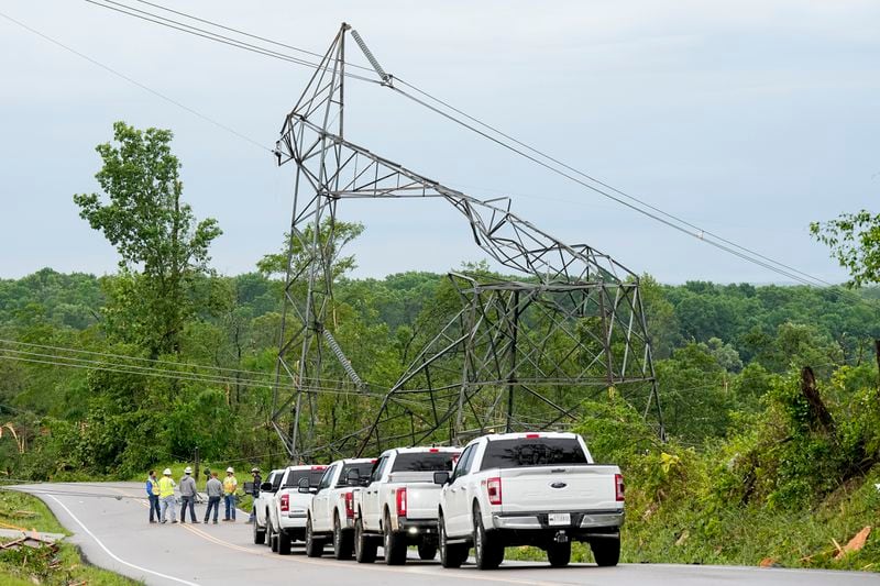 Utility workers survey a damaged TVA tower Thursday, May 9, 2024, in Columbia, Tenn. Severe storms tore through the central and southeast U.S., Wednesday, spawning damaging tornadoes, producing massive hail, and killing two people in Tennessee. (AP Photo/George Walker IV)