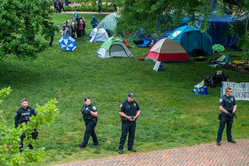 Police form a line where pro-Palestinian protesters set up tents on the grounds of the University of Virginia, in Charlottesville, Va., Saturday, May 4, 2024. (Cal Cary/The Daily Progress via AP)