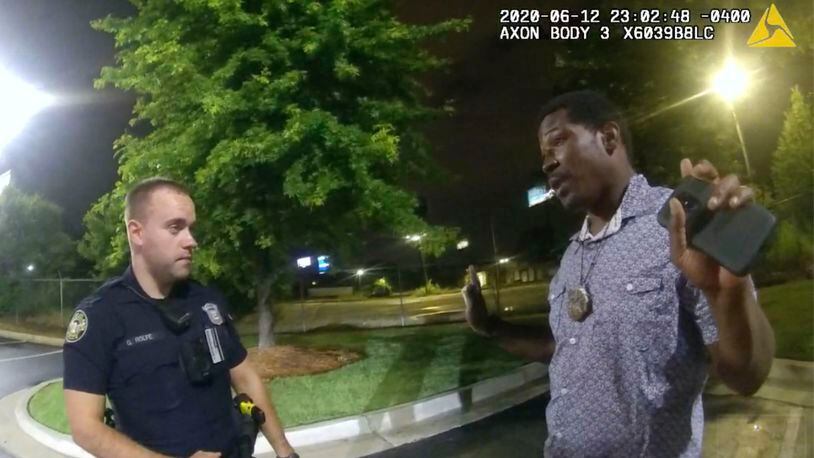 FILE- In this June 12, 2020 file photo from a screen grab taken from body camera video provided by the Atlanta Police Department Rayshard Brooks speaks with Officer Garrett Rolfe in the parking lot of a Wendy's restaurant, in Atlanta. Rolfe has been fired following the fatal shooting of Brooks and a second officer has been placed on administrative duty. The Fulton County District Attorney will announce charging decisions in the fatal shooting of Brooks during a news conference, Wednesday, June 17, 2020 in Atlanta. (Atlanta Police Department via AP, File)