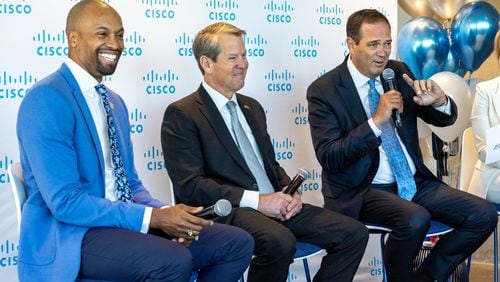 (L-R) Donald Beamer Jr., senior technology officer with the Mayor’s Office; Gov. Brian Kemp; and Chuck Robbins, CEO of Cisco, appear on a panel at Cisco’s new office space at Coda in Atlanta on Tuesday, April 11, 2023. (Arvin Temkar / arvin.temkar@ajc.com)