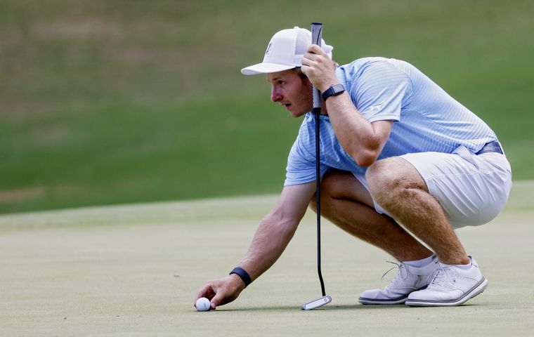 Carson Bacha, from Auburn University, who won the tournament, lines up a putt during the final round of the Dogwood Invitational Golf Tournament in Atlanta on Saturday, June 11, 2022.   (Bob Andres for the Atlanta Journal Constitution)