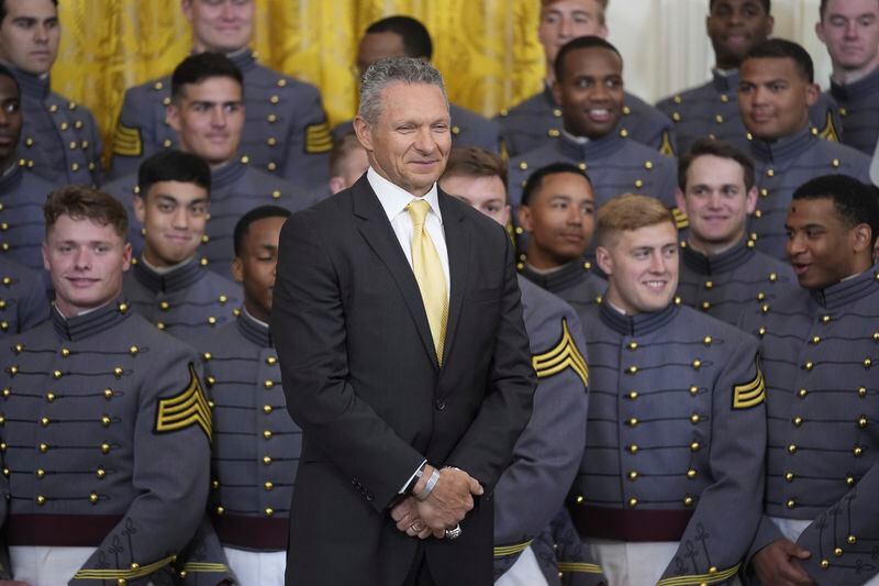 Head coach Jeff Monken, stands with his team, during an event where President Joe Biden presented the Commander-in-Chief's Trophy to the United States Military Academy Army Black Knights, in the East Room of the White House, Monday, May 6, 2024, in Washington. (AP Photo/Evan Vucci)