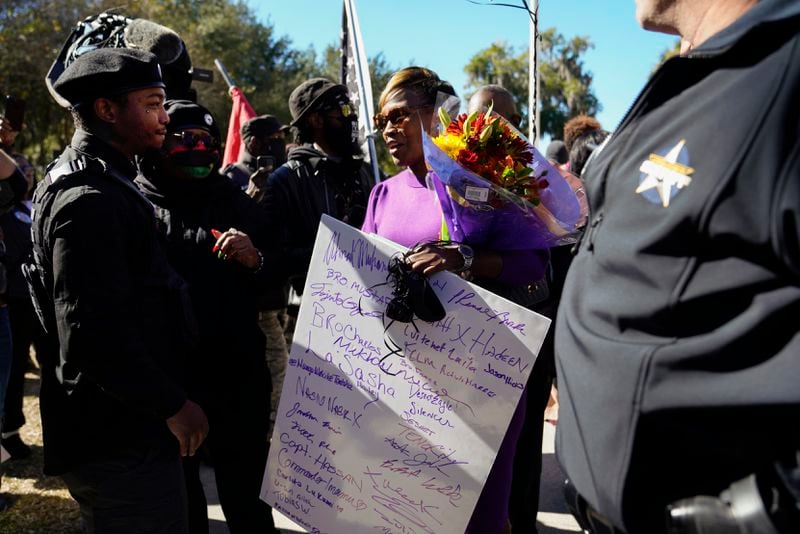 Wanda Cooper-Jones, the mother of Ahmaud Arbery, recieves gifts from supporters outside the Glynn County Courthouse on Tuesday. 
(Nicole Craine/The New York Times)